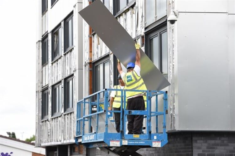 Men building outside a building