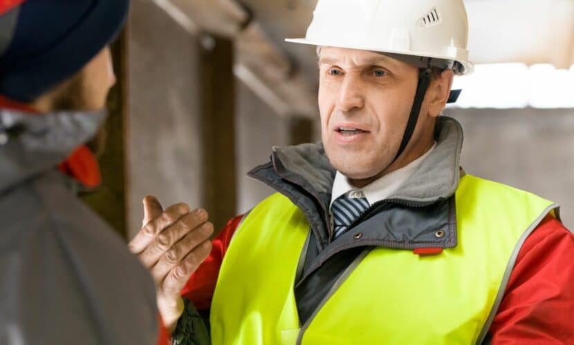 Image of a male construction worker speaking to somebody