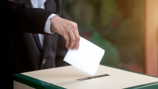 person casting a vote