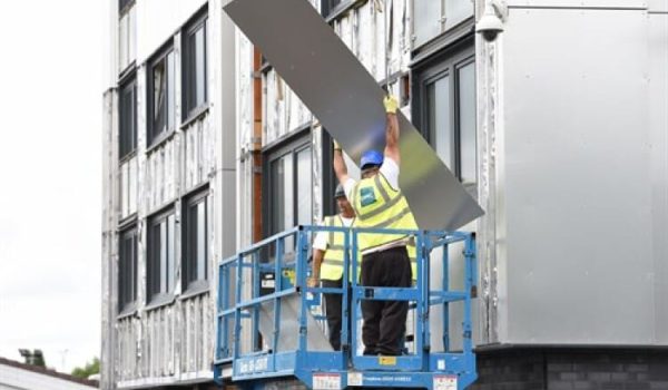 Men building outside a building