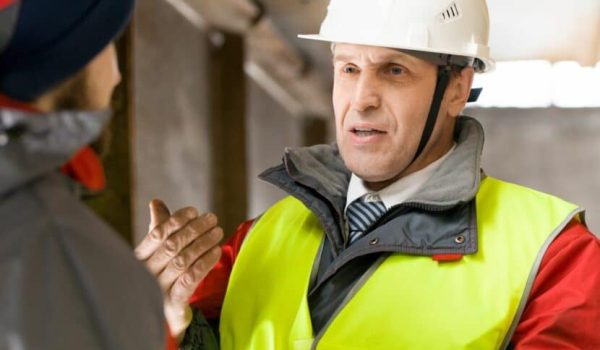 Image of a male construction worker speaking to somebody